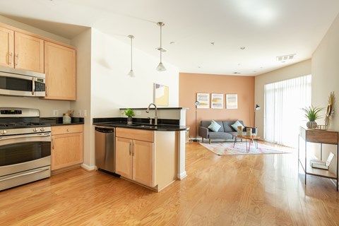 A kitchen with wooden cabinets and a black countertop.