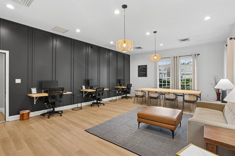 A modern office space with wooden floors and black chairs.
