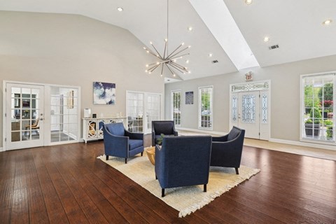 a living room with couches and chairs and a chandelier