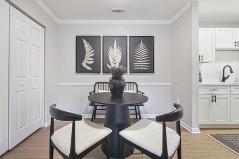 A black and white dining room with a table and chairs.
