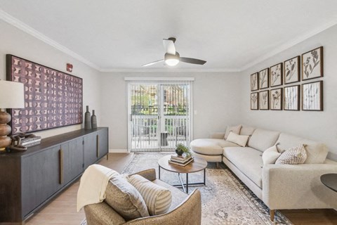 A living room with a white couch, a brown chair, and a coffee table.