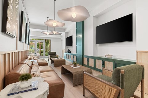 A living room with a brown couch and a green chair.