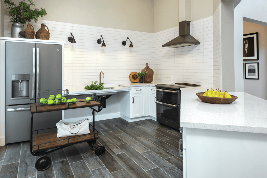 A kitchen with a black fridge and a white counter.