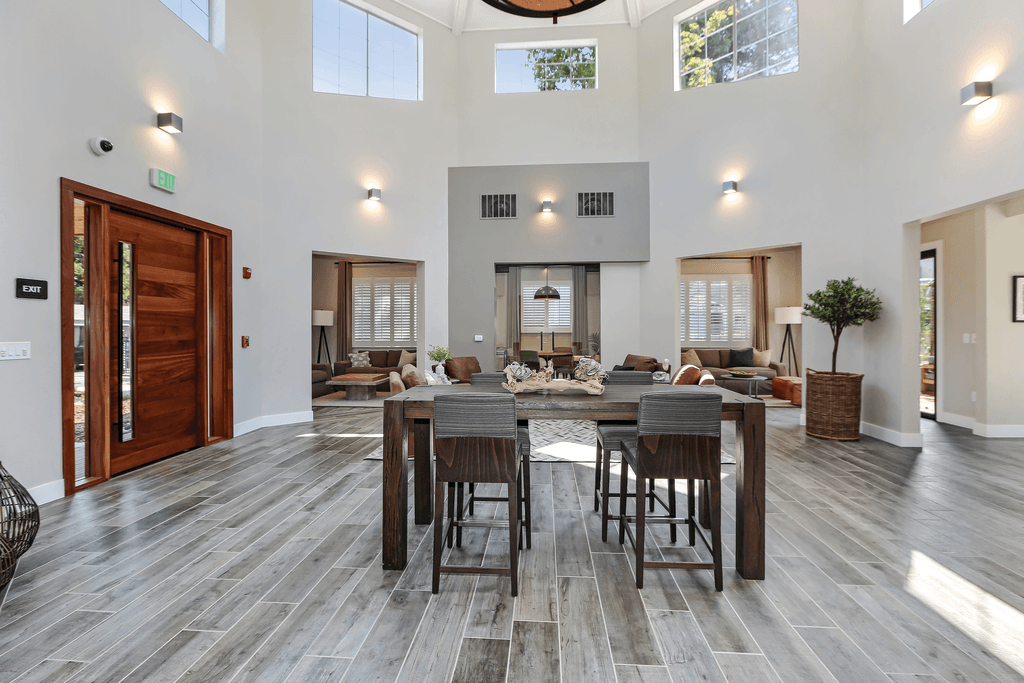 A modern dining room with a large table and chairs.