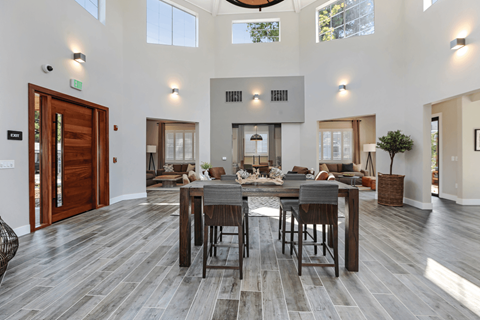 A modern dining room with a large table and chairs.