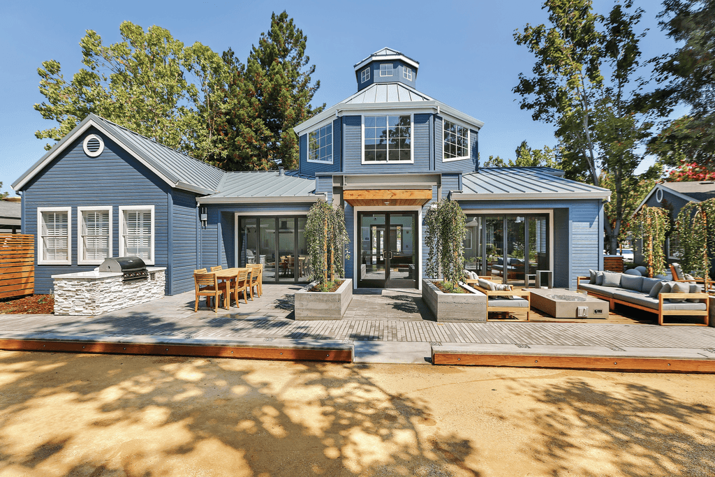 A blue house with a white roof and a black door.