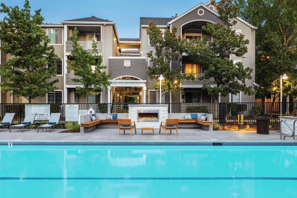 A large house with a pool in front.