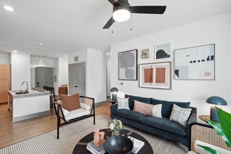 a living room with a couch, chairs and a table