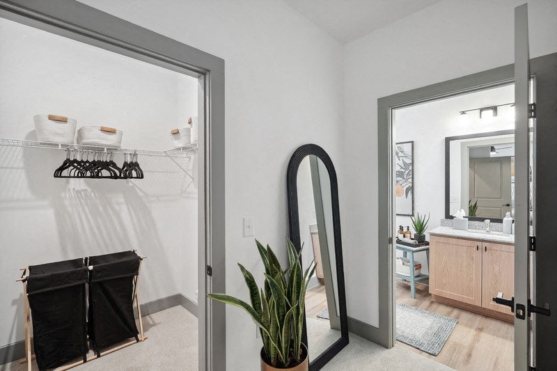 a bathroom with a large mirror and a closet with a mirror