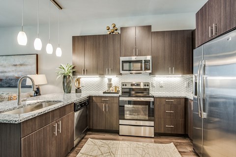 a kitchen with stainless steel appliances and marble counter tops