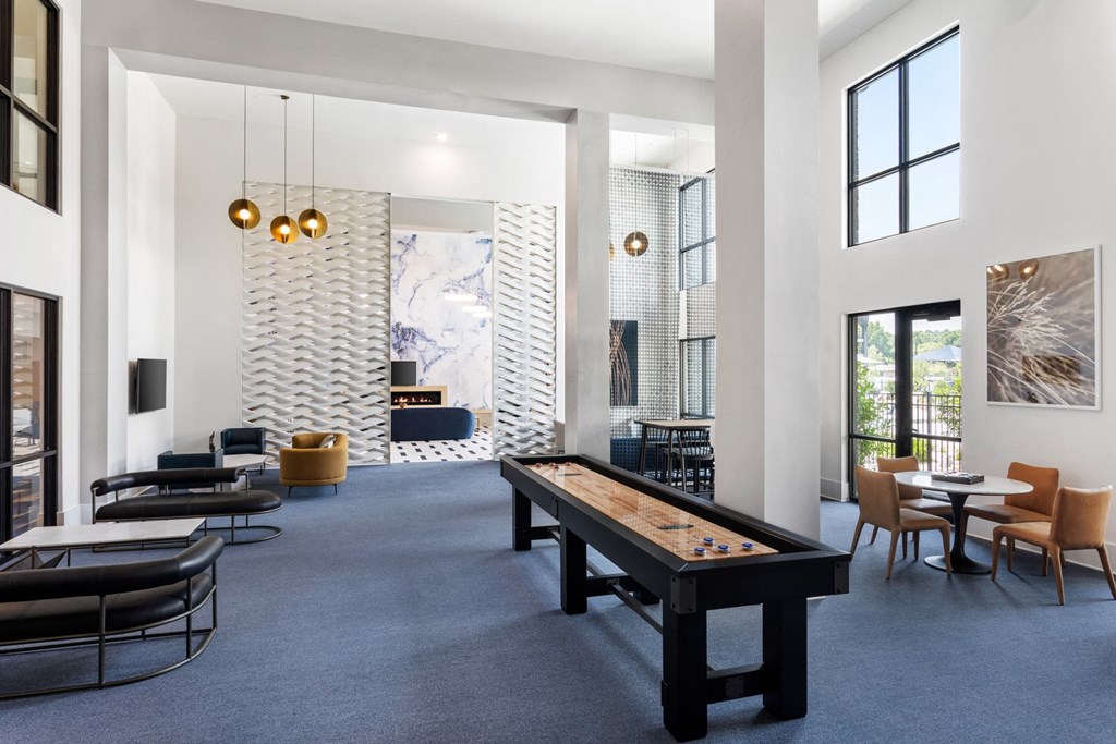 A billiard table is in the middle of a room with a blue carpet.