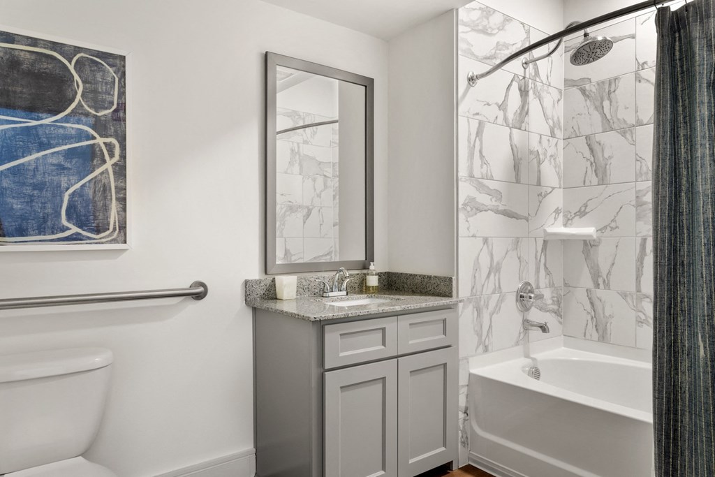 a bathroom with a shower and a sink and a toilet