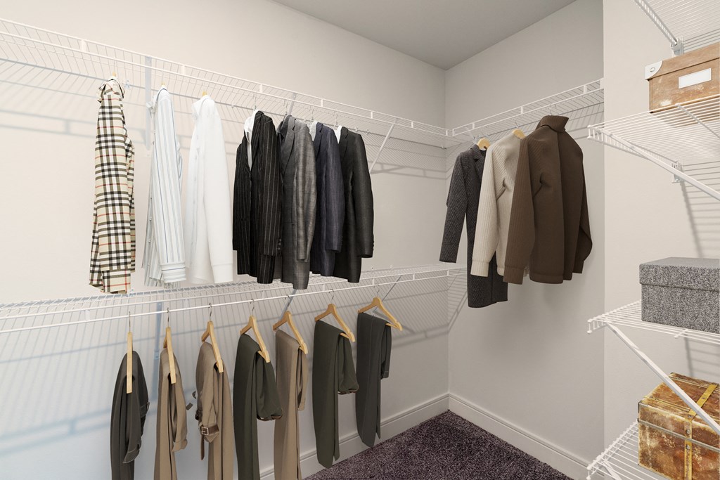 a closet with clothes hanging