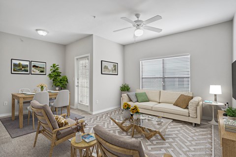 an open living room and dining room with a couch and chairs and a table