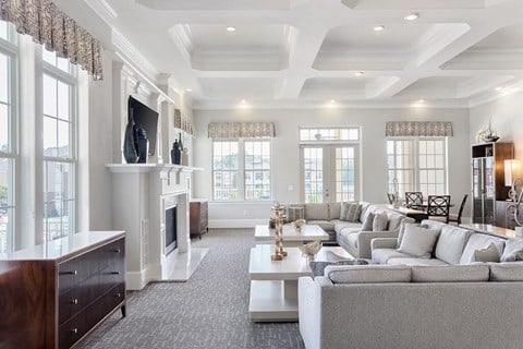 a white living room with couches and a fireplace