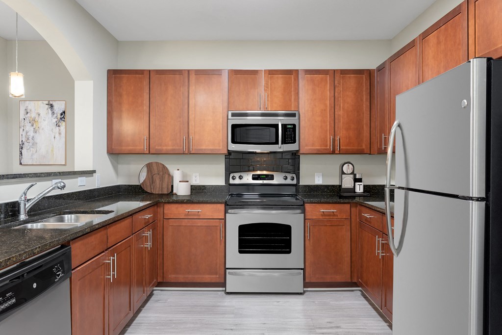 a kitchen with stainless steel appliances and wooden cabinets