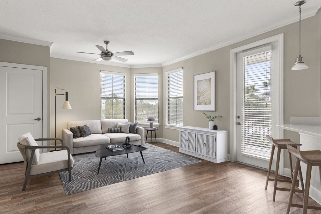 a living room with a couch and a table and a ceiling fan