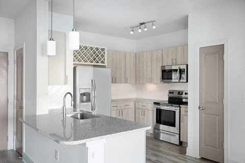 a kitchen with a sink and a refrigerator