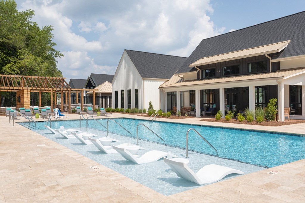 Refreshing swimming pool with shallow water lounge chairs.
