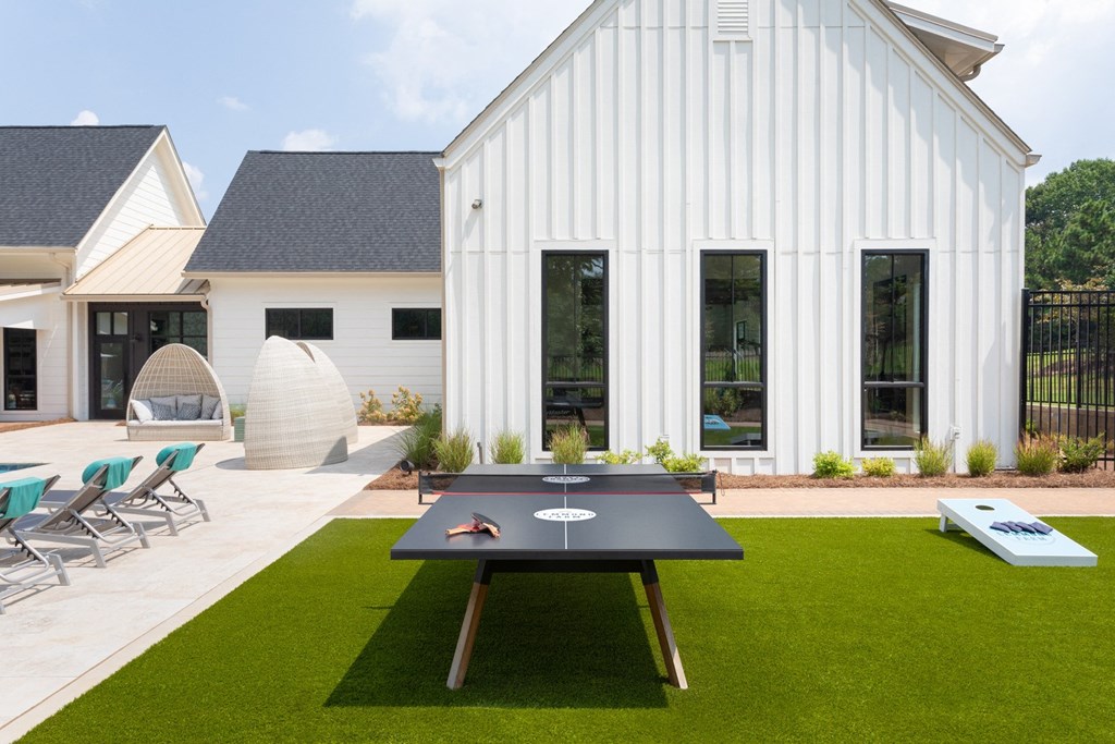 Outdoor recreation area with ping pong table and resident lounge.