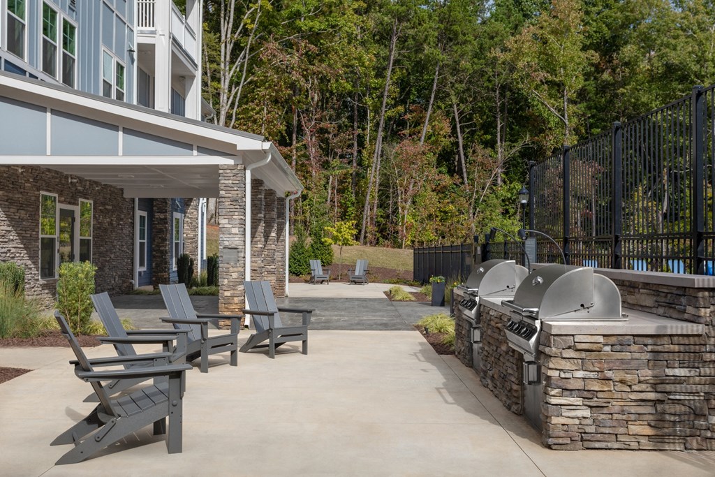 exterior outdoor kitchen with seating and grills