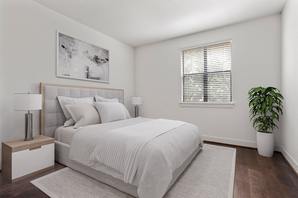 an all white bedroom with a bed and a window