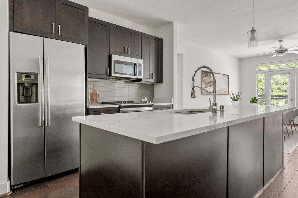 a kitchen with stainless steel appliances and a white counter top