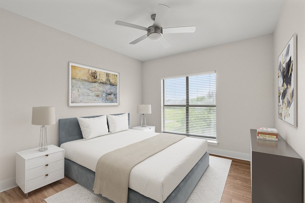 a bedroom with a large bed and a ceiling fan
