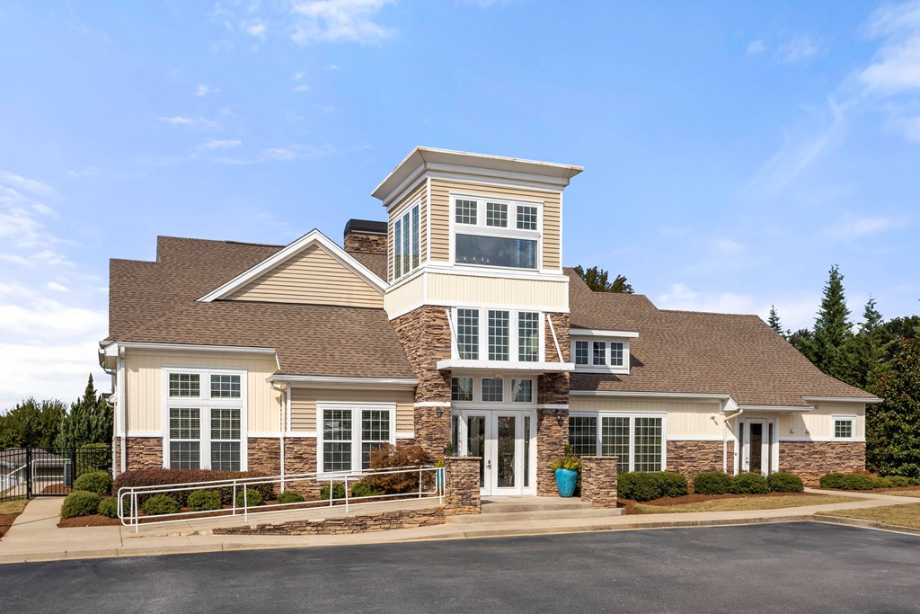 a large house with white and brown bricks and a roof