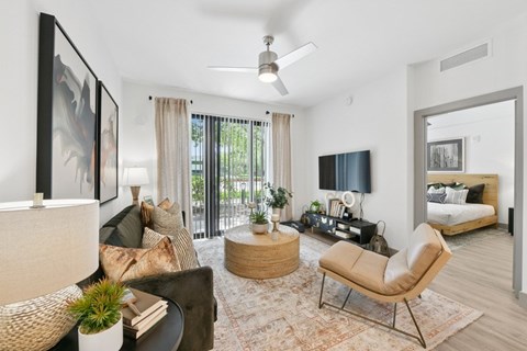 A living room with a brown chair and a white couch.