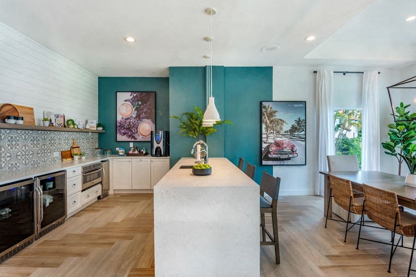 a kitchen and dining room with blue walls and wood floors