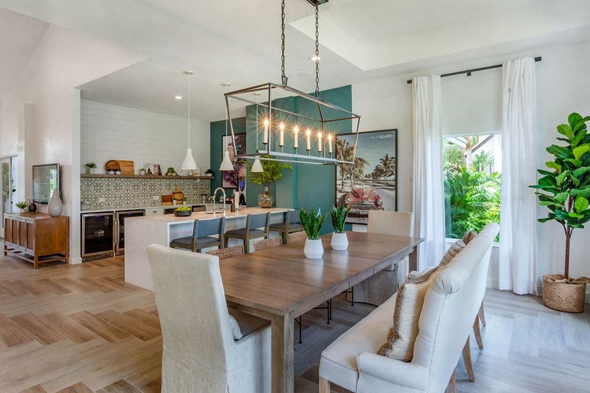 a dining room and kitchen with a table and chairs