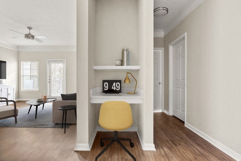 a home office with white walls and a yellow chair