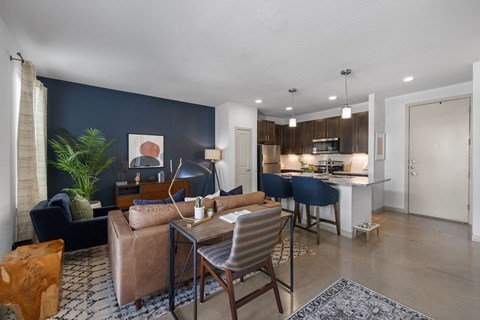 A living room with a dark blue wall and a white ceiling.