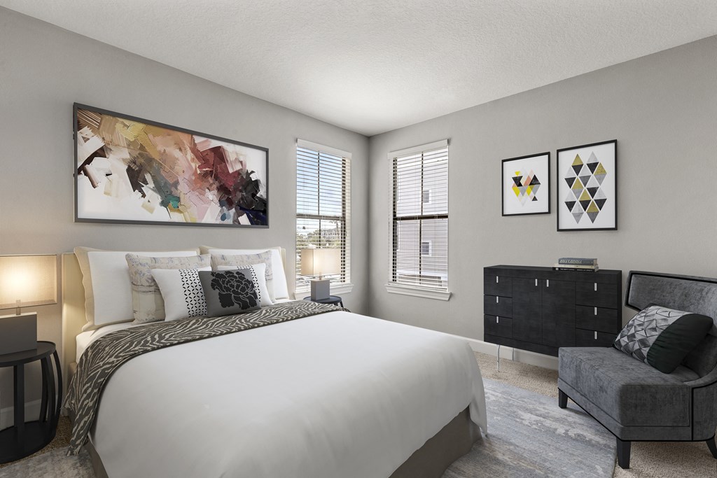 a bedroom with a bed and a chair and a window