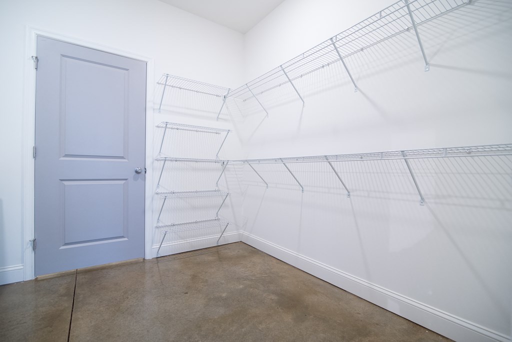 a room with white walls and a blue door in it