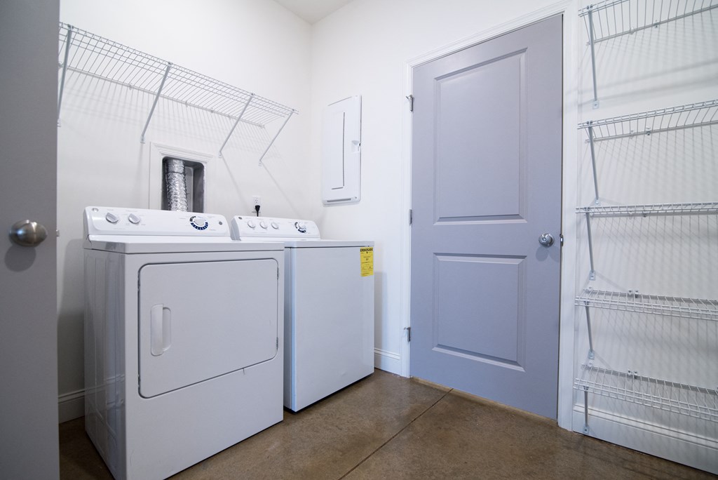 a laundry room with a washer and dryer and a door