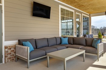 exterior outdoor lounge with seating and tv - Photo Gallery 18