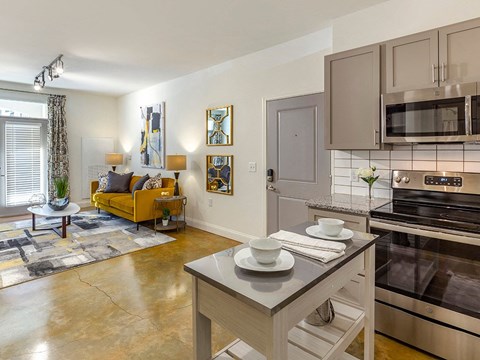 a kitchen with stainless steel appliances and a table
