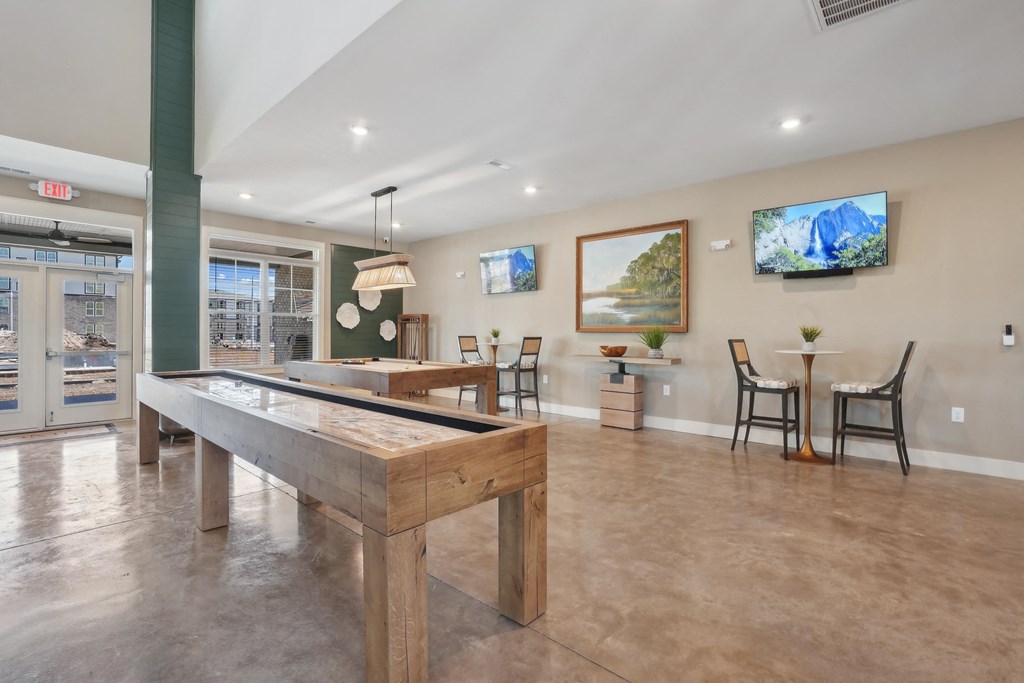 a game room with a pool table and a bar