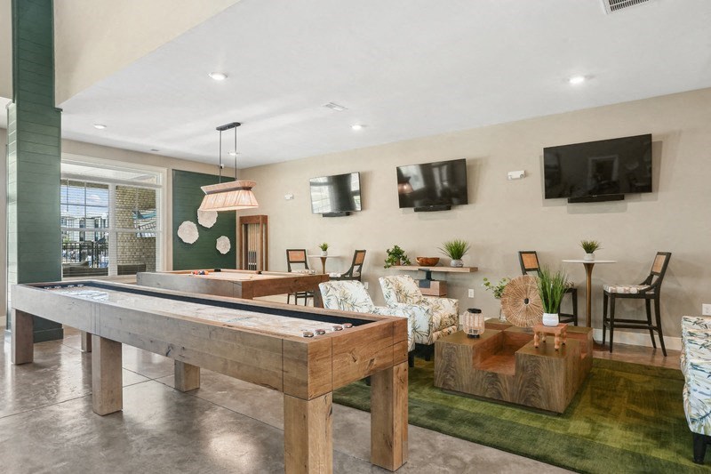 a living room with a pool table and a television