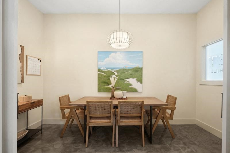 a dining room with a wooden table and chairs