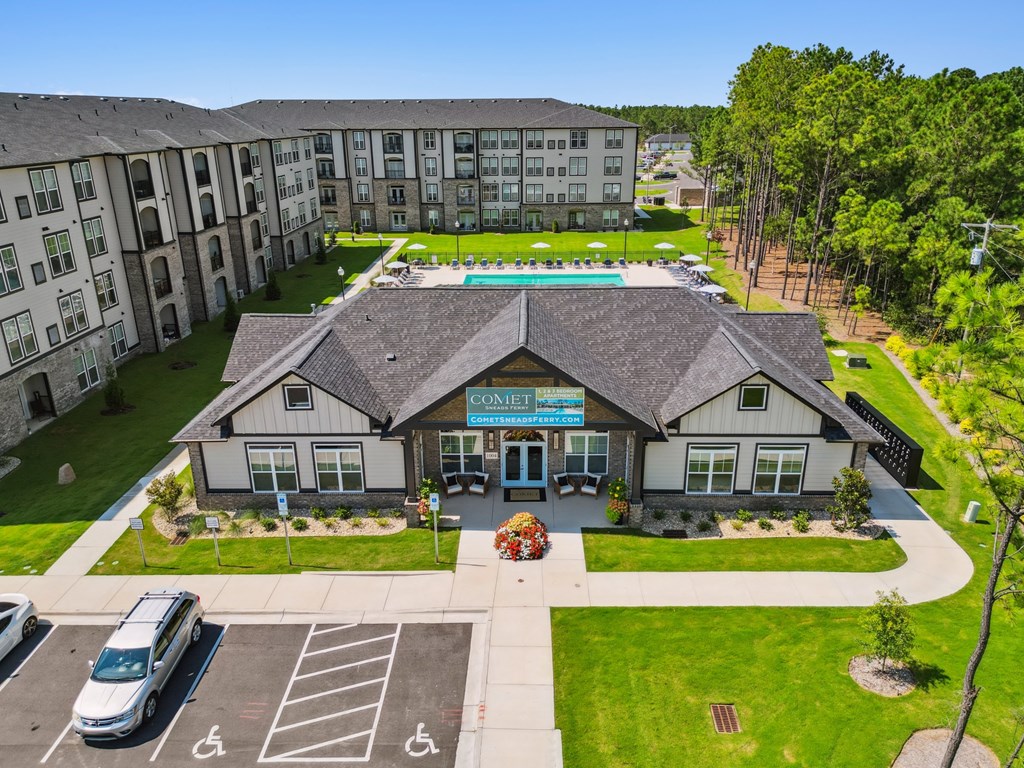 A building with a pool in the middle of a grassy area.