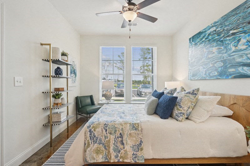 a bedroom with a bed and a ceiling fan