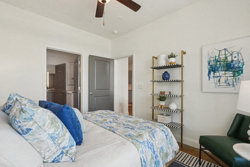 a bedroom with a bed and a ceiling fan