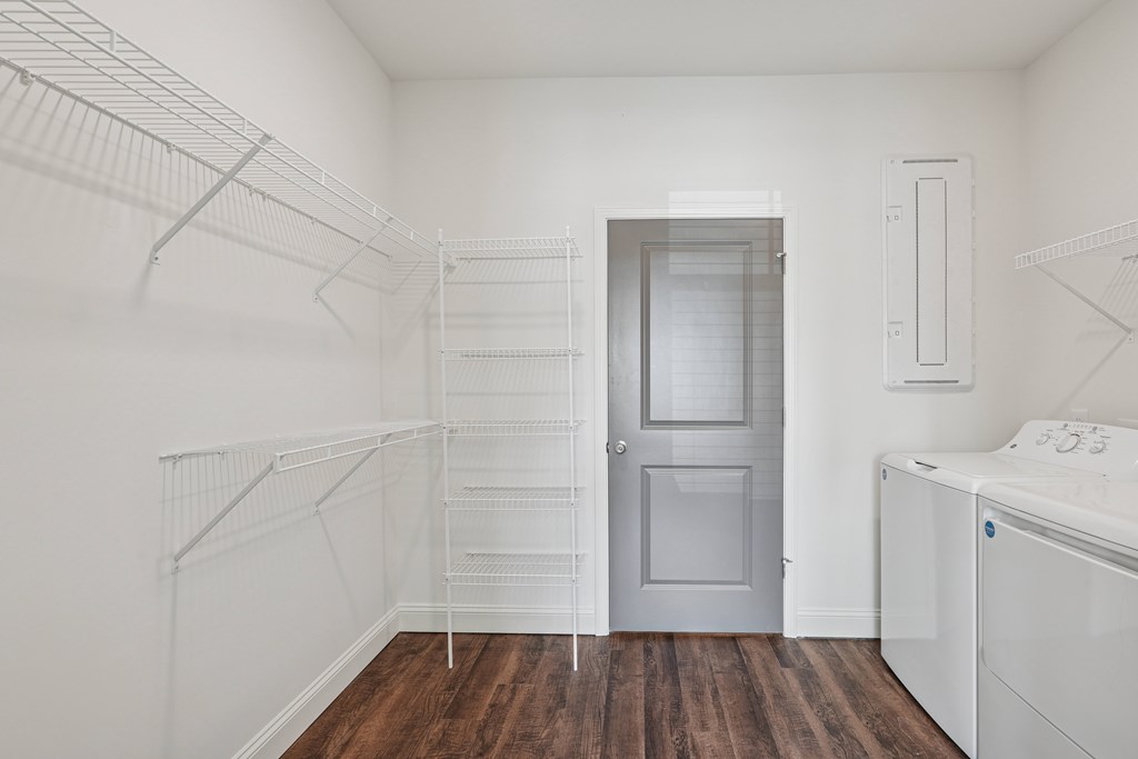 A white laundry room with a washer and dryer.
