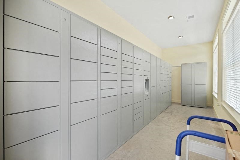 a long hallway with many cabinets and a door