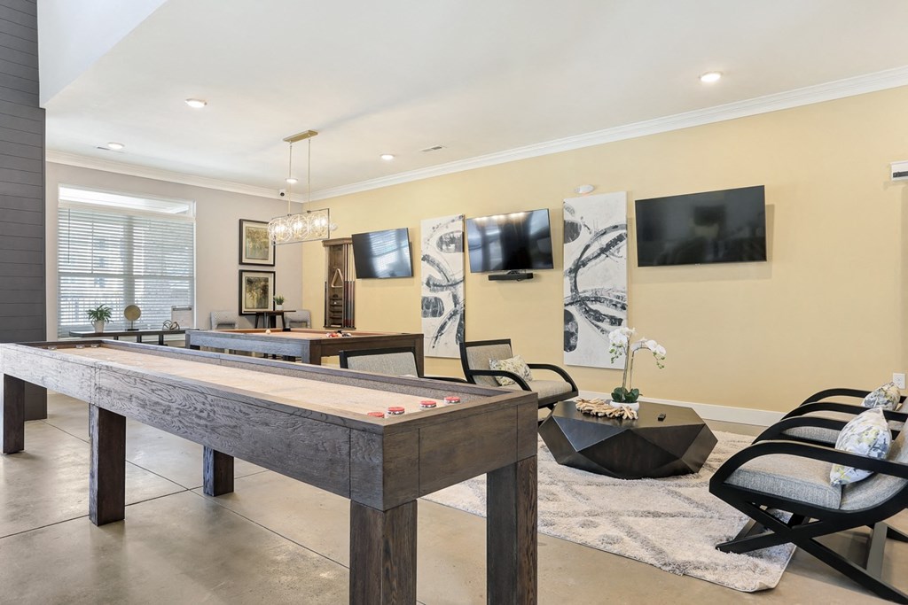 a game room with a pool table and a tv