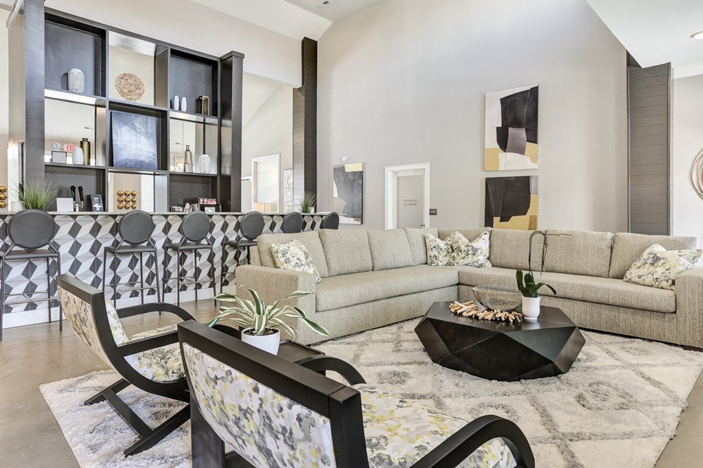 a clubhouse with couches and chairs and a table