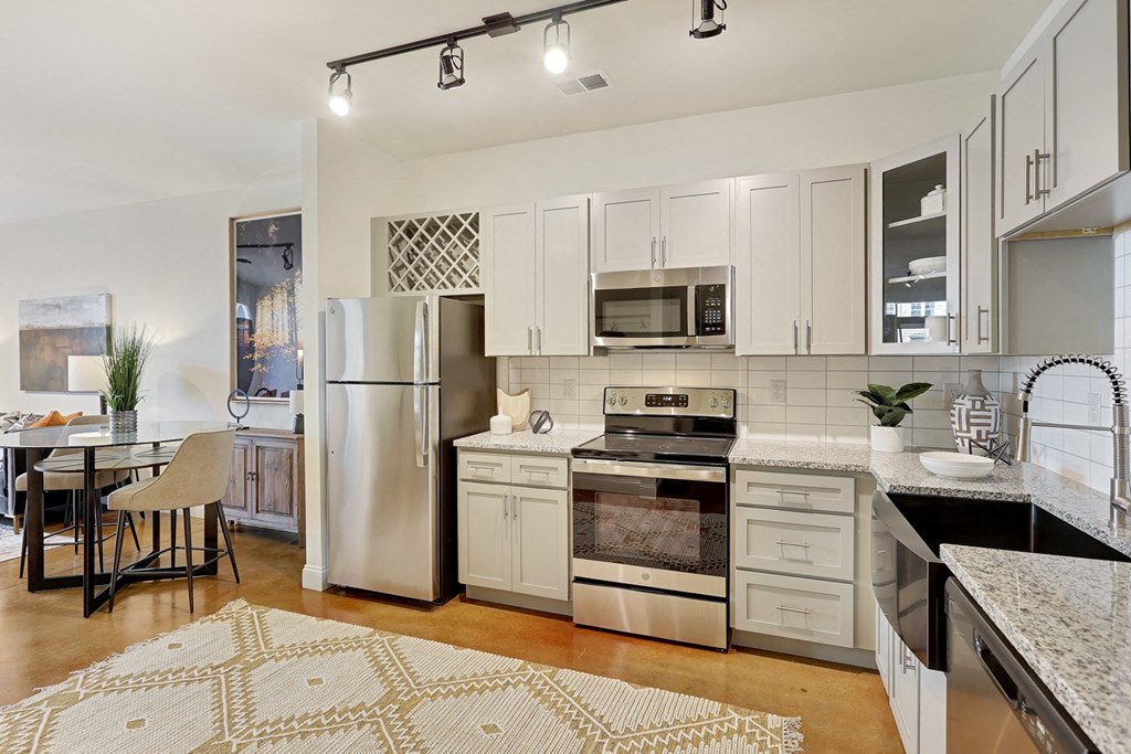 a kitchen with stainless steel appliances and white cabinets